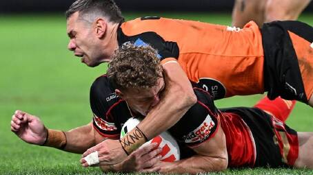Wests Tigers centre Brent Naden collects Dolphins winger Jack Bostock in the head with his forearm. (Dave Hunt/AAP PHOTOS)