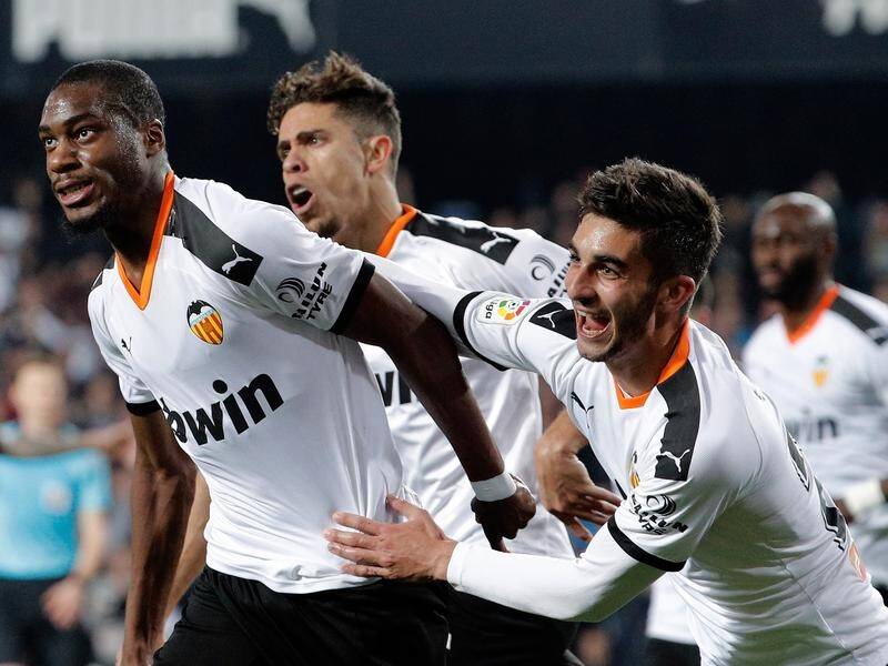 Geoffrey Kondogbia (L) celebrates equalising for Valencia against Atletico Madrid.