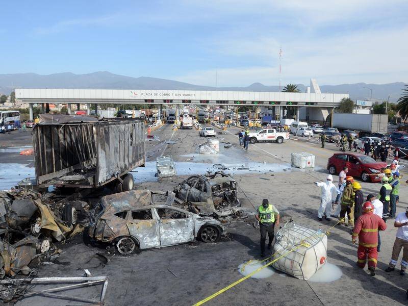 A truck has crashed into a toll booth in Mexico, igniting a large fire and killing 19 people.