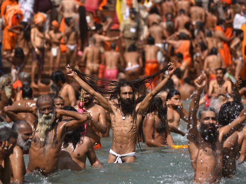 Masses of pilgrims have taken a holy dip in the Ganges, raising fears of a virus surge.