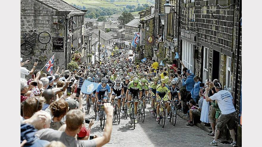 The peloton rides up Haworth High Street during stage 2 of Le Tour de France in Haworth, England. Picture: Getty Images