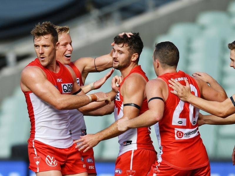 Four goals from Isaac Heeney (2L) have led Sydney to a three-point round-one AFL win over Adelaide.