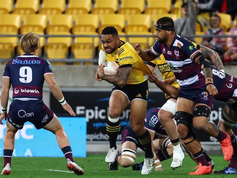 Queensland Reds players come to grips with the Hurricanes' Ngani Laumape in Wellington.