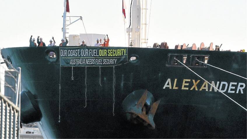 The crew of the fuel tanker Alexander Spirit can't leave the ship but acknowledge the support of protesters at East Devonport on Saturday. Picture: NEIL RICHARDSON