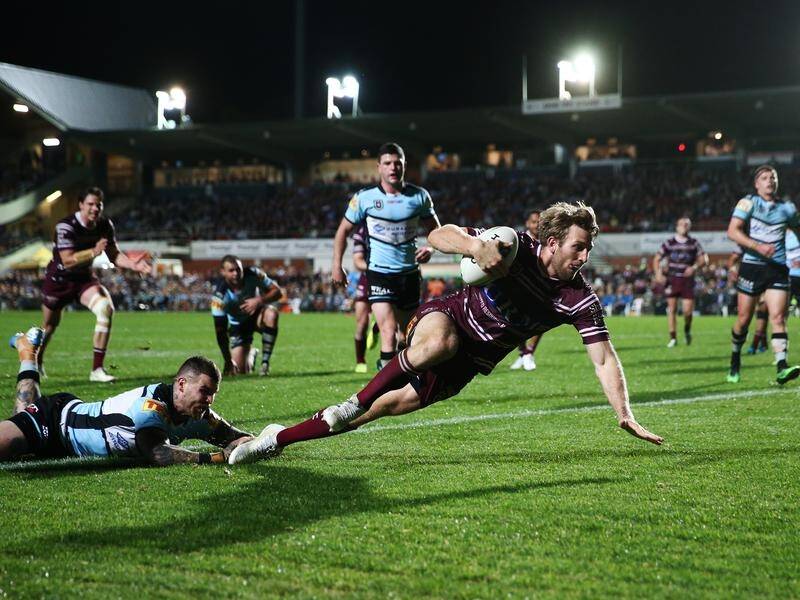 Brendan Elliot of the Sea Eagles scores a try during his side's comprehensive win over Cronulla.