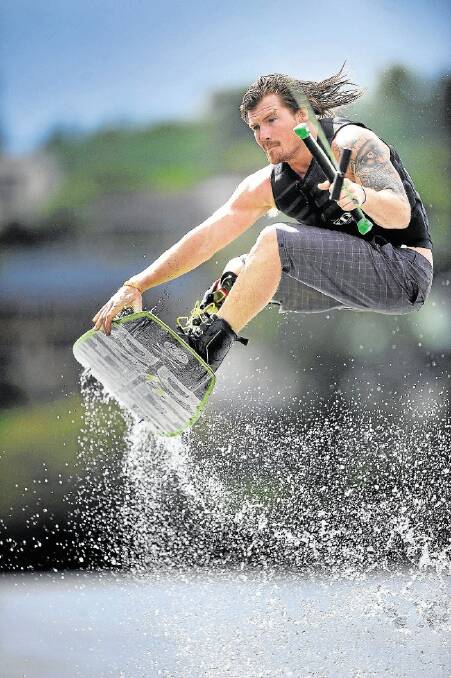 Marcus Bush gets high during a training run on Trevallyn Dam ahead of the TasWake state titles final round next weekend. Picture: SCOTT GELSTON