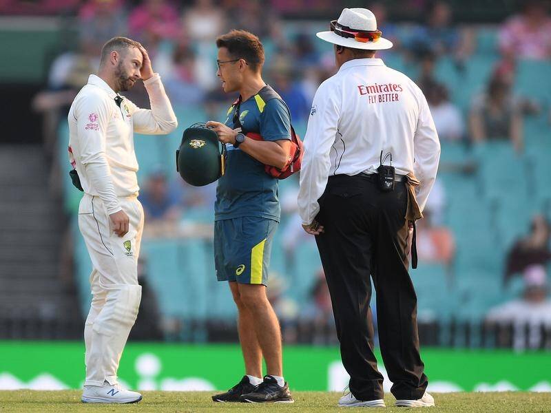 Matthew Wade was treated on the field after being struck on the helmet while fielding at the SCG.