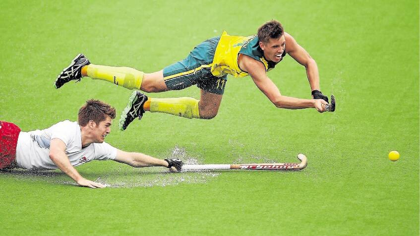 Tasmanian Eddie Ockenden scores the fourth goal for Australia as Henry Weir of England reaches out in vain during the Commonwealth Games semi-final match. Picture: GETTY IMAGES
