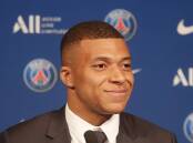 A smile worth A$7m-a-month? Kylian Mbappe discusses his decision to stay at hometown Paris SG.