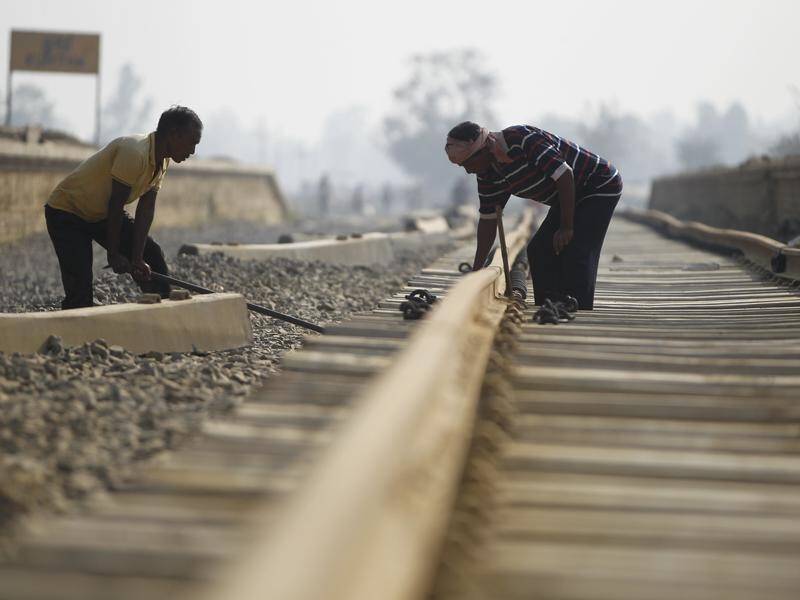 Nepalese construction laborers work on the Himalayan mountain nation's first modern railway.