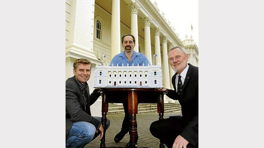Deputy Mayor Jeremy Ball, model maker Ken Draeger and Mayor Albert van Zetten with Mr Draeger's Lego town hall. Picture: NEIL RICHARDSON