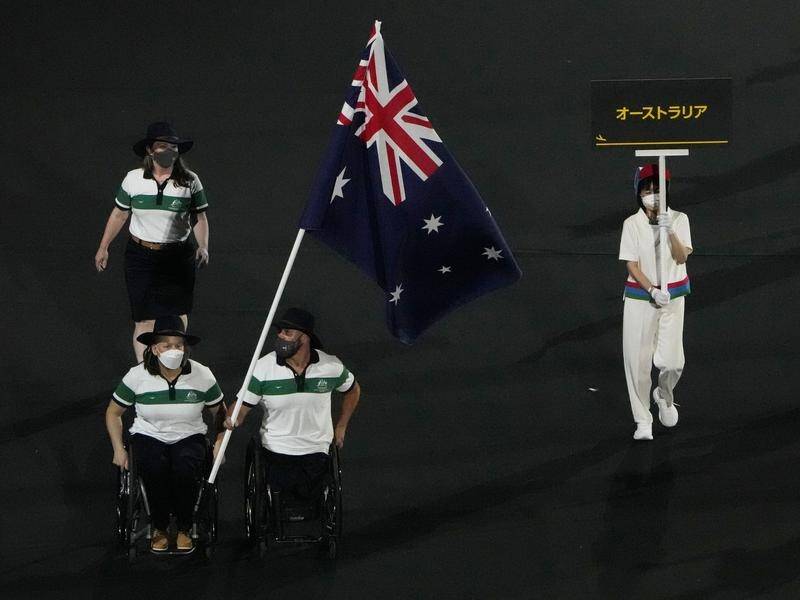 Danni di Toro and Ryley Batt carry Australia's flag in the Paralympics' opening ceremony.