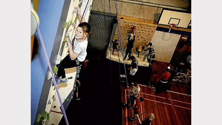 Taylah Latham, 11, tried out the indoor climbing wall at Launceston's PCYC. Picture: Geoff Robson. 
