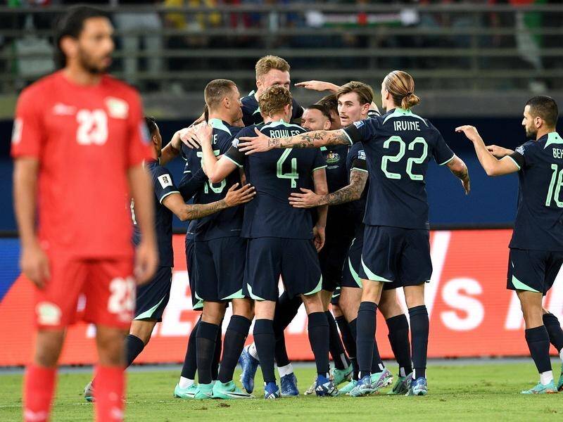 Australian players congratulate Harry Souttar (tallest) on scoring the only goal against Palestine. (EPA PHOTO)