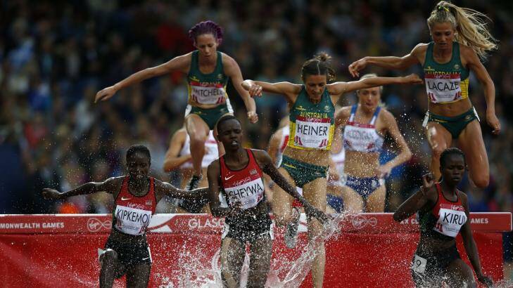 Big jump: LaCaze, at right, in the final of the 3000m steeplechase at the Glasgow Games.  Photo: AFP/Adrian Dennis