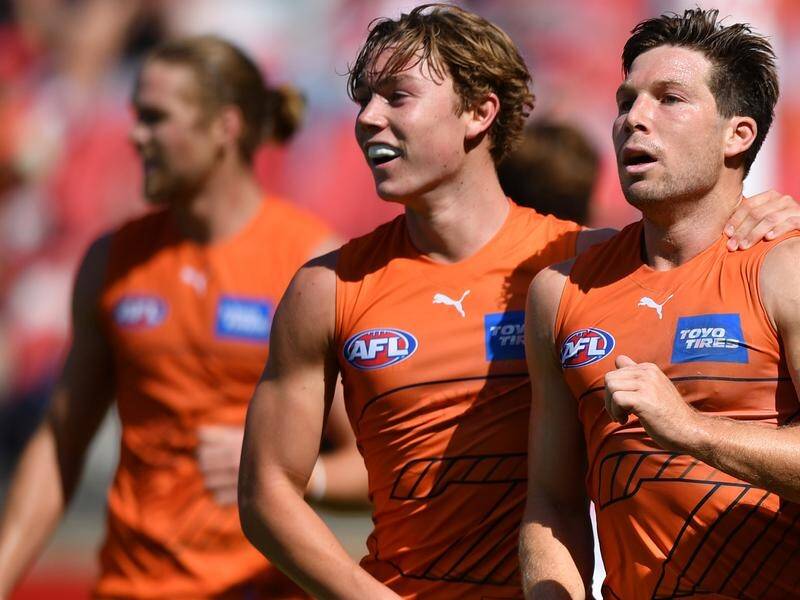 Tanner Bruhn (c) and Toby Greene (r) starred for GWS in their AFL practice game win over Sydney.