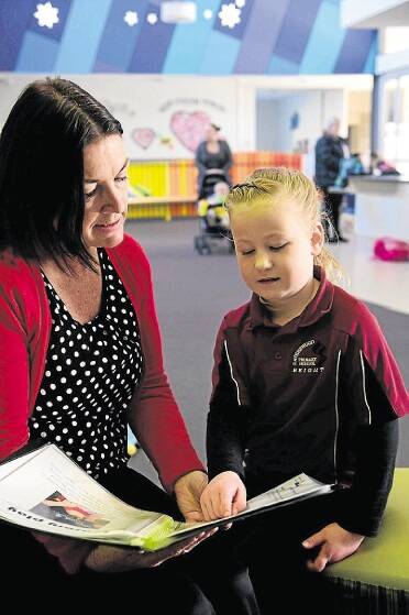 Primary school nurse Jenna Bayes talks with Ravenswood Primary School pupil Lucy Hawkins, 5. Picture: PAUL SCAMBLER