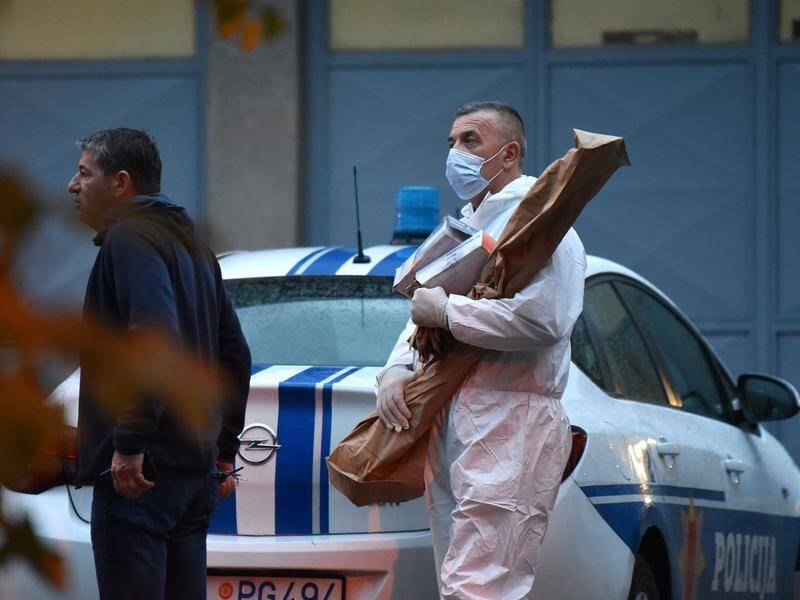 Investigators remove evidence from the scene of a mass shooting in Montenegro. (EPA PHOTO)