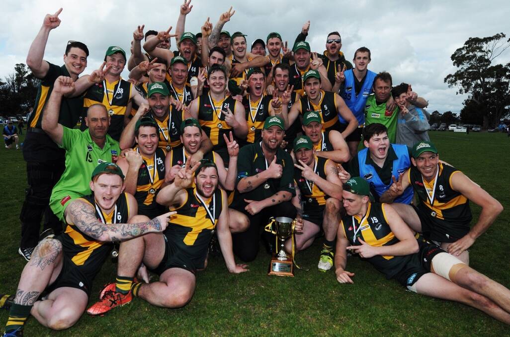Winners are grinners... St Pats Reserves celebrate their grand final victory over Evandale. Picture: GEOFF ROBSON