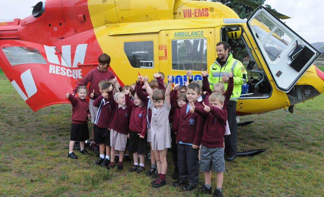 Star of the Sea College pupils pose with pilot Chris Fahey in front of the Tasmania Police Westpac Rescue Helicopter. Picture: Paul Scambler