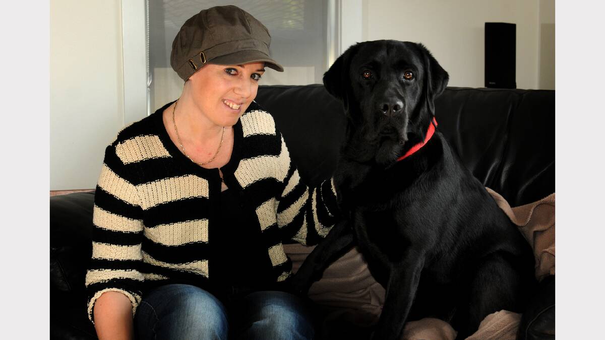 Cancer sufferer Amanda Reid, of Prospect, with her dog, Beau. She needs to raise money for treatment. Picture: Geoff Robson