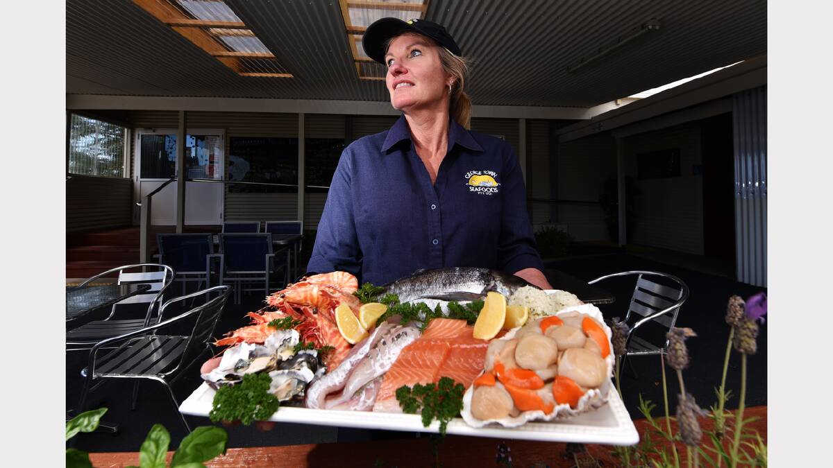Sharon Tricker, of George Town Seafoods, with a platter of some of the most popular seafood items for Christmas. Picture: SCOTT GELSTON