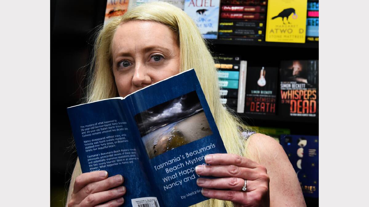 Author Melanie Calvert with her new book on the murder of Italian tourist Victoria Cafasso and the disappearance of Nancy Grunwaldt. Picture: NEIL RICHARDSON