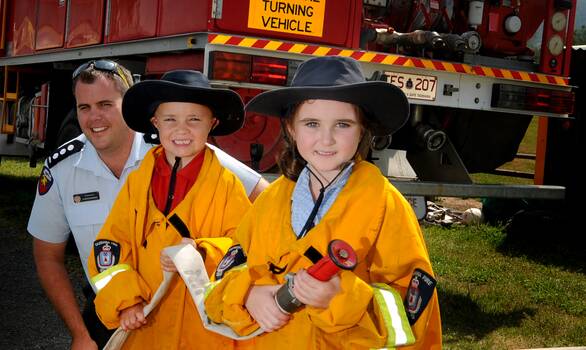 Brisbane-based firefighter Clinton Neumann with Mole Creek Primary School pupils Tannah Webb, 5, and Addison Drake, 6. Picture: GEOFF ROBSON