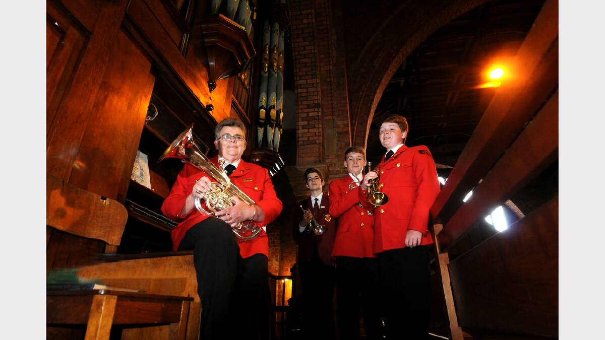 Kim Brundle-Lawrence, Lachlan Hindrum, 13, Ryan Stuart, 11, and Stuart Stenton, 12 warm up their instruments in preparation for the Christmas concert. Picture: GEOFF ROBSON
