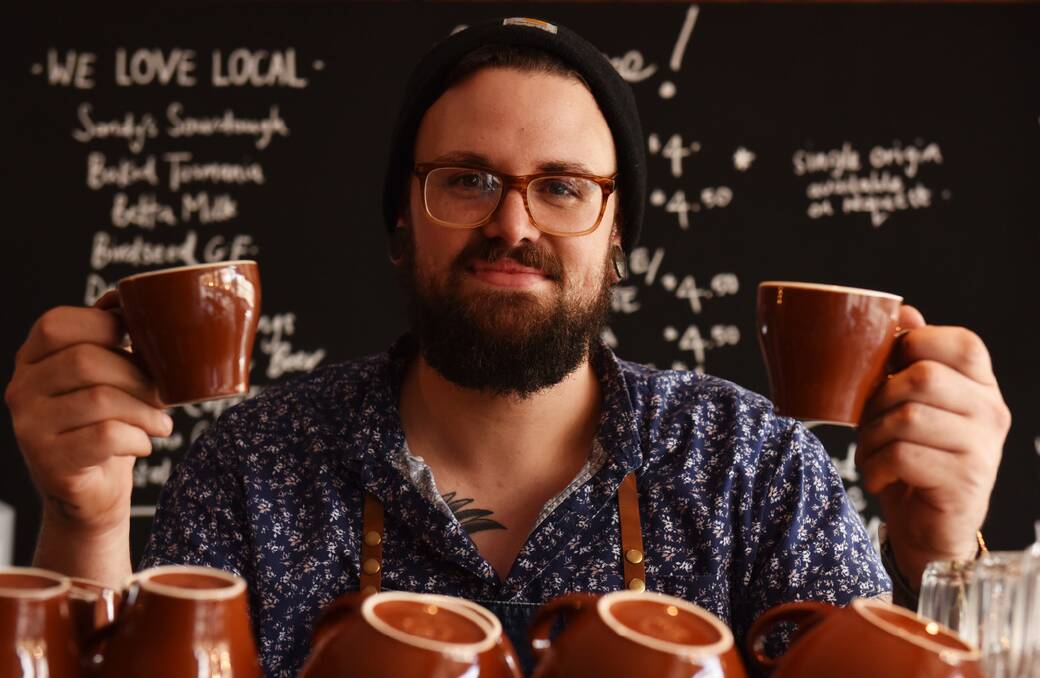 The new co-owner of Amelia Espresso, Jack McNiff, with two cups of their finest coffee. Picture: SCOTT GELSTON