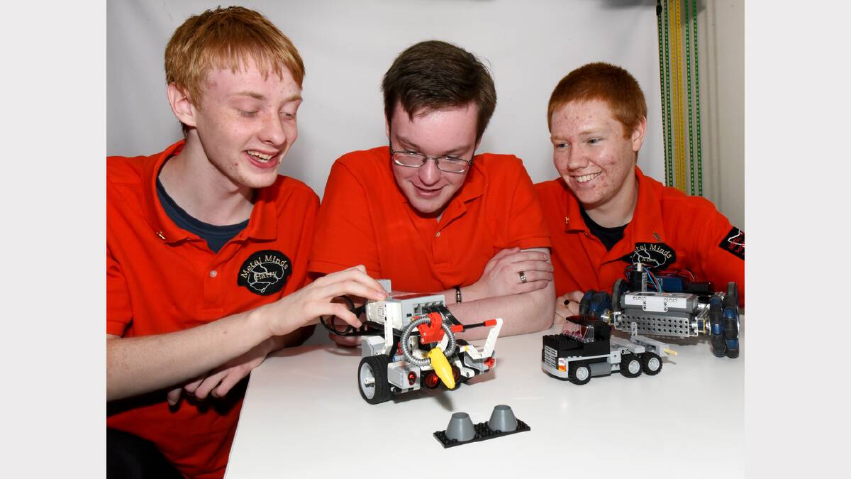 Metal Minds Robotics members Harry Heathcote, Nathan Smallbon and Alex Mountney demonstrate the capability of their robotic creations. Picture: NEIL RICHARDSON