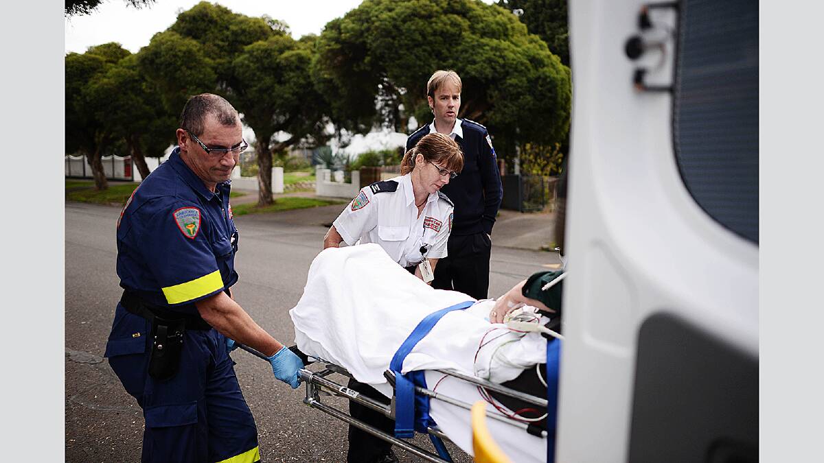 Paramedic Andy Warnes and intensive care paramedic Angela Hodgson load a patient as Northern region duty manager Lynden Ferguson supervises. Picture: Scott Gelston