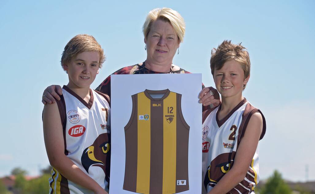 Junior footballers Liam Markham and Lachie Ranson with Prospect Hawks TSL president Michelle Strickland, showing the jumper of the Prospect Hawks team at the club's launch in October. 
