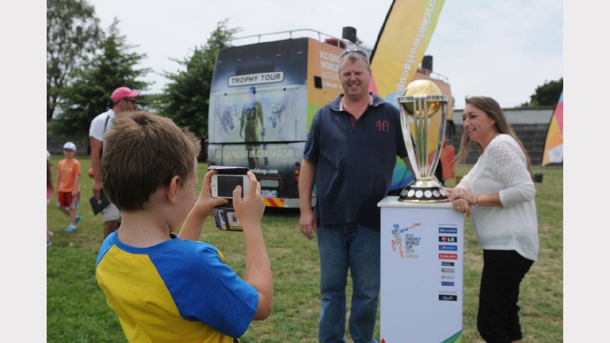 Craig and Jo Thomas, of Albury New South Wales, have their photo taken by their son Lachlan, 8, with the cup. Picture: Paul Scambler

