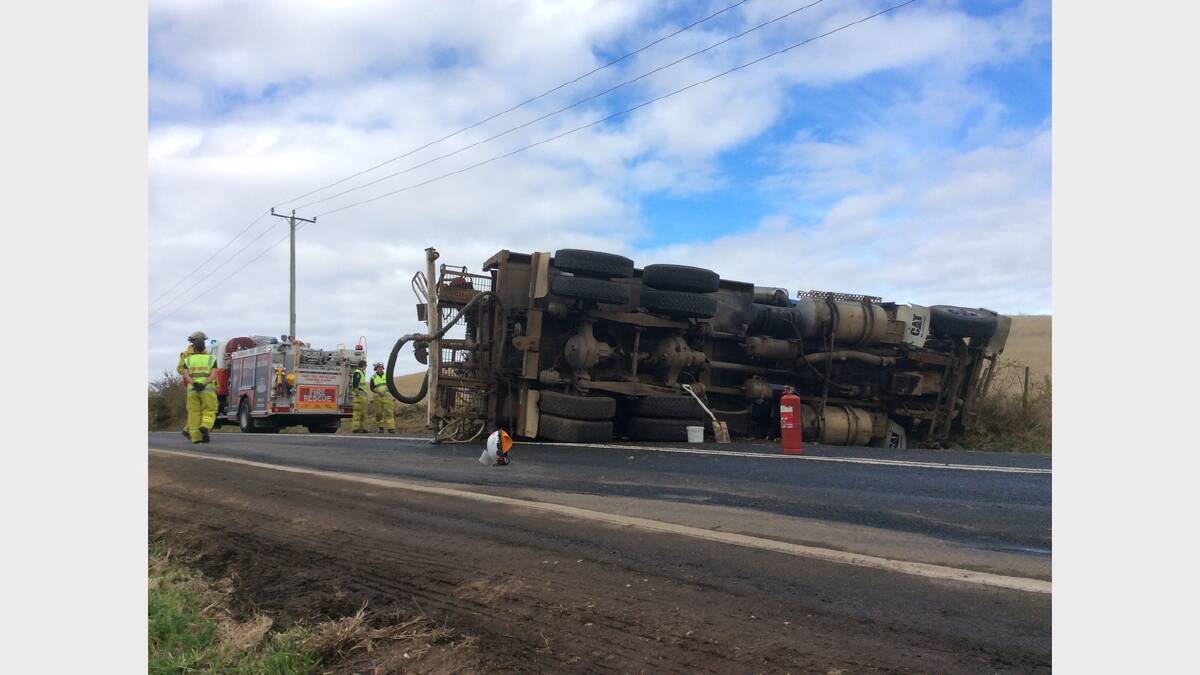 A driver has been taken to hospital with minor injuries after his truck rolled at St Leonards this morning. Picture: Caroline Tang