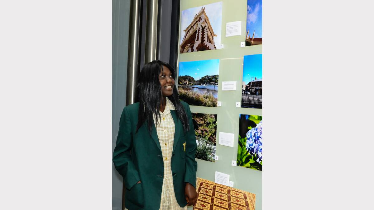 St Patrick's College student Dorothy Wani looks at her entries in the Vision and Voice exhibition. Picture: Neil Richardson