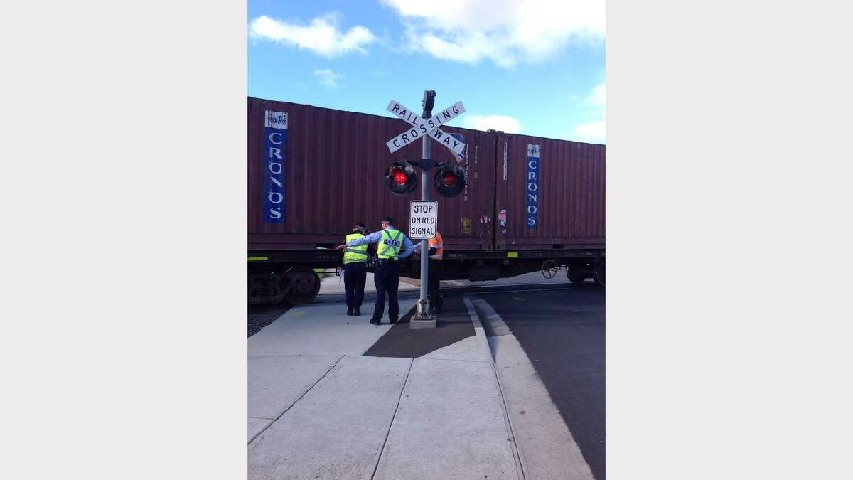 Crash investigators and forensics are on the scene at a Claremont level crossing where a woman was hit by a train earlier today. Picture: Georgie Burgess