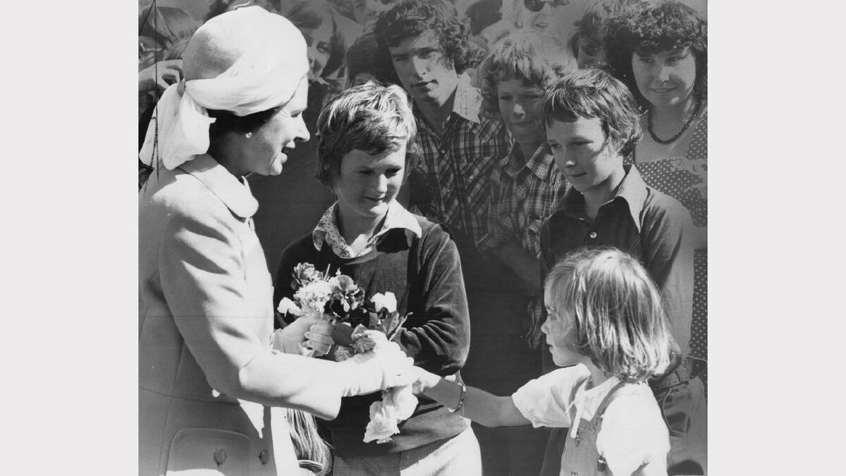 Queen Elizabeth and Prince Philip's 1977 royal visit | Brother Angus and Simon Poxon watch as friend Carolyn Calvert, 5, of Camden, presents the Queen with a bunch of flowers. (Note the old school photoshopping)
