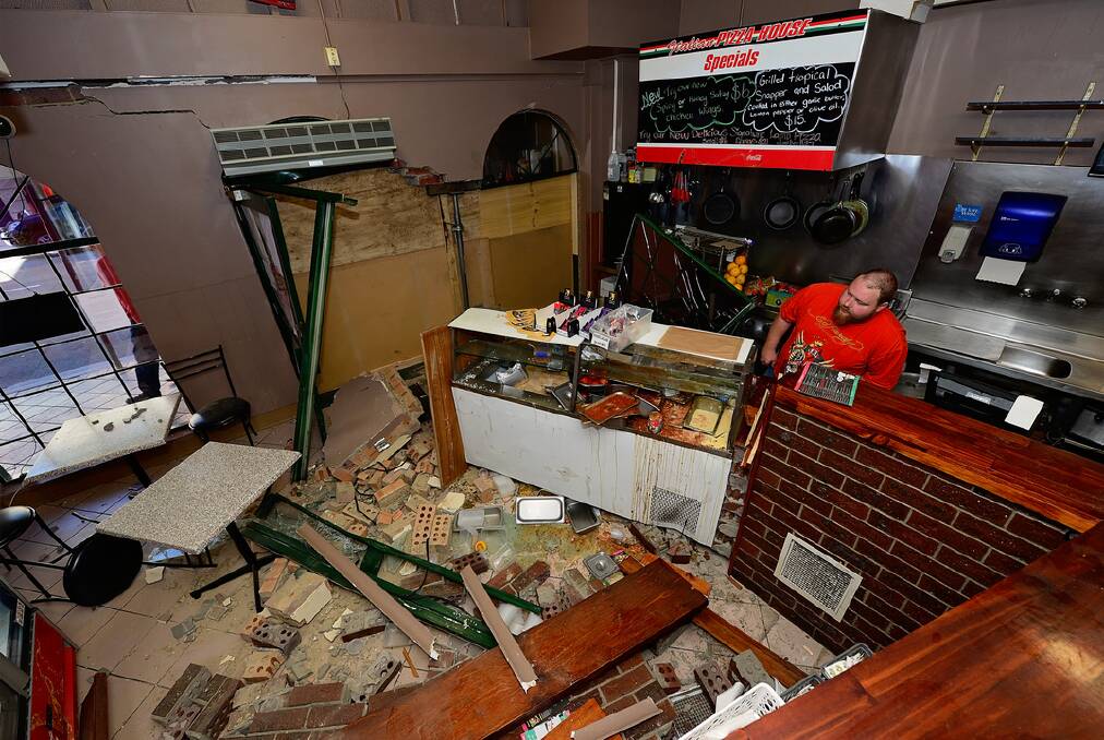 Italian Pizza House owner Heath Watson assesses the damage to his business yesterday. Picture: PHILLIP BIGGS
