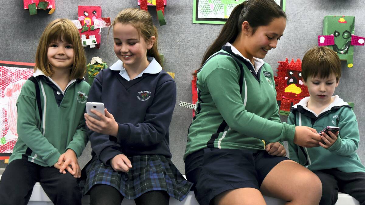Norwood Primary School students Sarah Nicolson, Chloe Allen,    Charlotte Howard and Nate Johnston use the MYTERN mobile app.Picture: NEIL RICHARDSON
