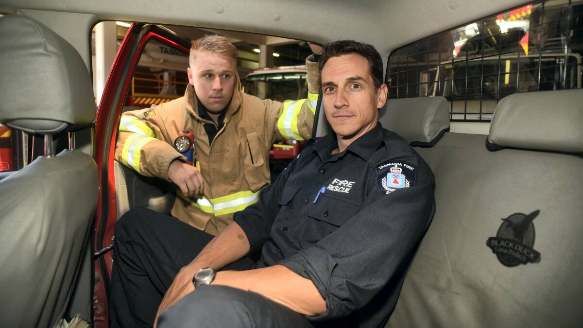 Launceston firefighters Roger Brown and Jim Preece remind drivers not to leave children and pets in cars on hots days. Picture: PAUL SCAMBLER