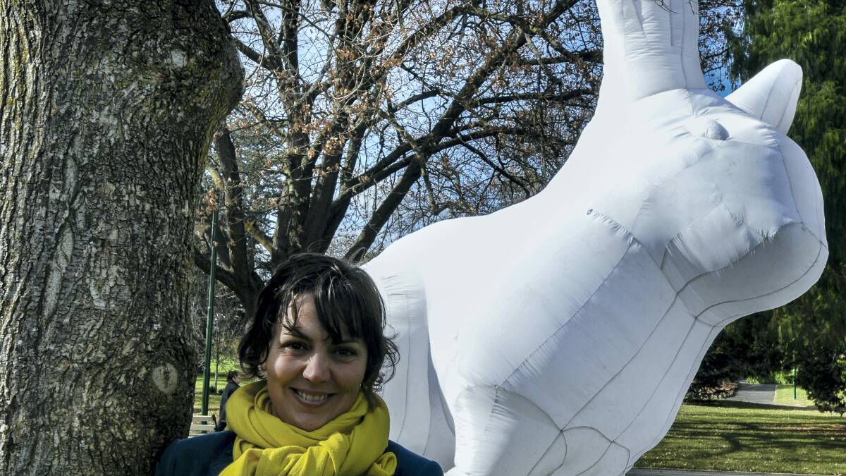 Junction Arts Festival creative director Natalie de Vito gets up close to Hobart artist Amanda Parer’s giant rabbit, which will be a standout installation in September. Picture: NEIL RICHARDSON