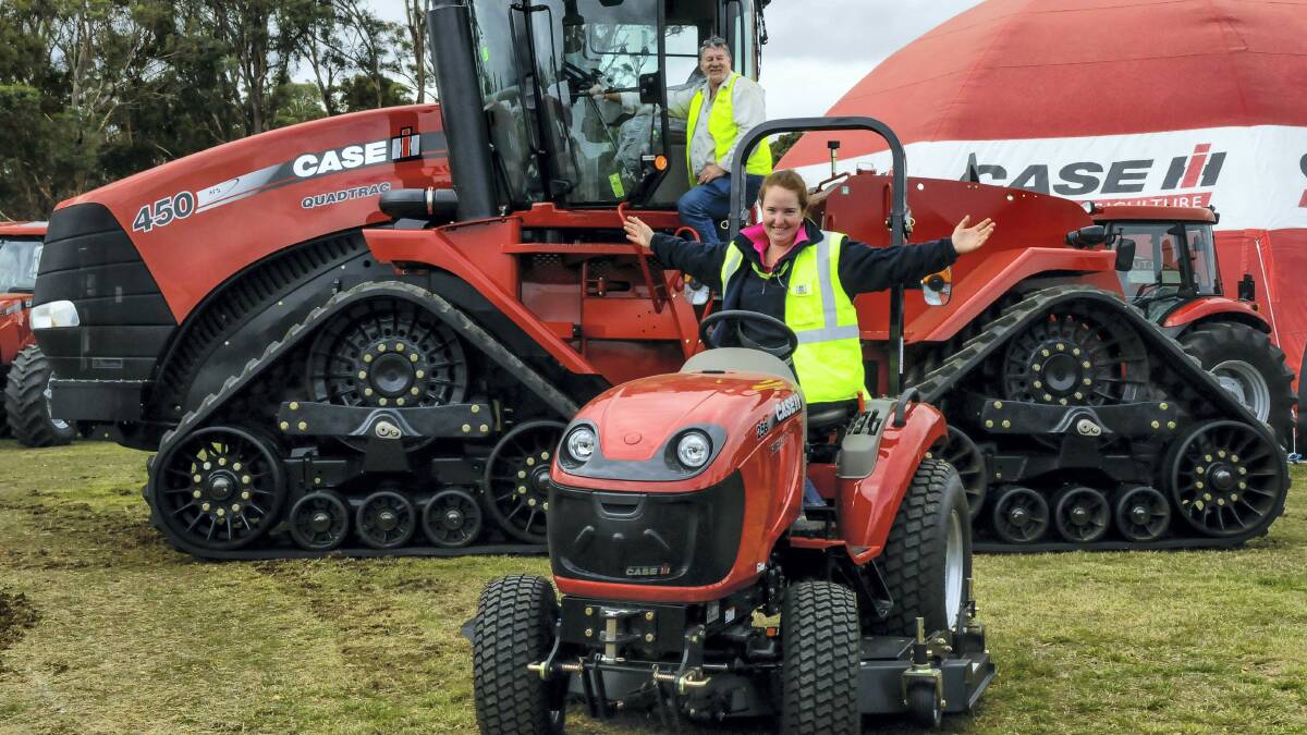 Farm Machinery Tasmania's Mick Boyd behind the wheel of the giant Case IH Quadtrac ... the impressive machine dwarfs Agfest chairwoman Amanda Bayles who expects the big red tractor to be a hit with visitors. Picture: NEIL RICHARDSON