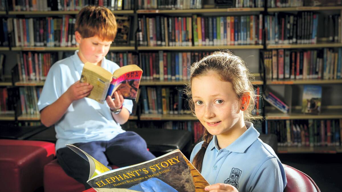 Grade 4 pupils Ella Copeland and Chi Canti in the library at Glen Dhu Primary School practising for the MS Readathon. Picture: PHILLIP BIGGS