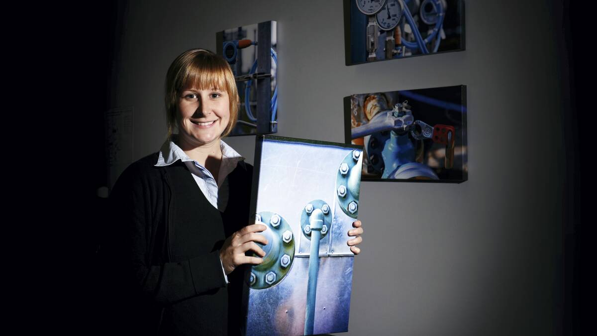 Tas Gas marketing assistant Sam Guy with some of the artworks that will be on display.

Picture: SCOTT GELSTON