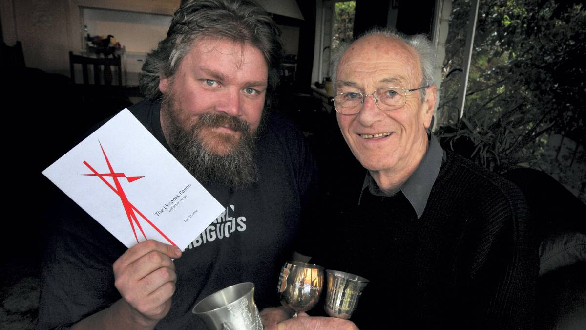 Tasmanian Poetry Festival director Cameron Hindrum and festival founder Tim Thorne with a book of poems and some of his past awards.  Picture: GEOFF ROBSON