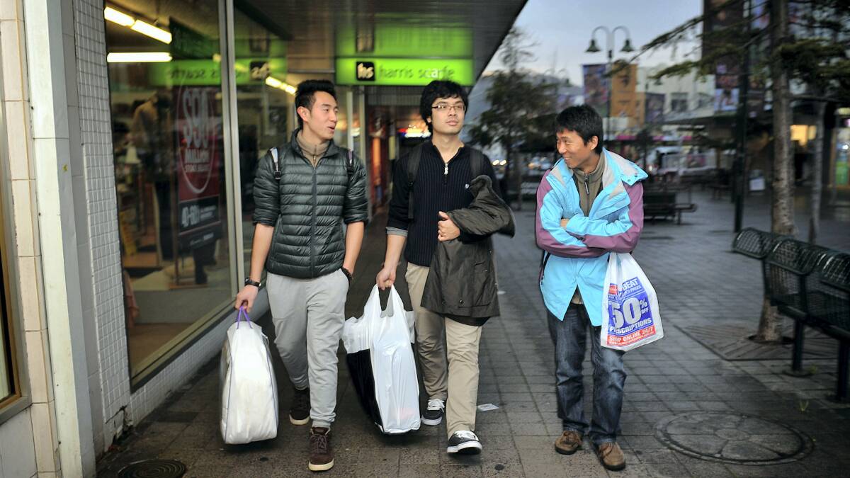 University of Tasmania international students Sean Ji, Tim Wei and Leon Liu shopping in Launceston yesterday. 

 Picture: SCOTT GELSTON