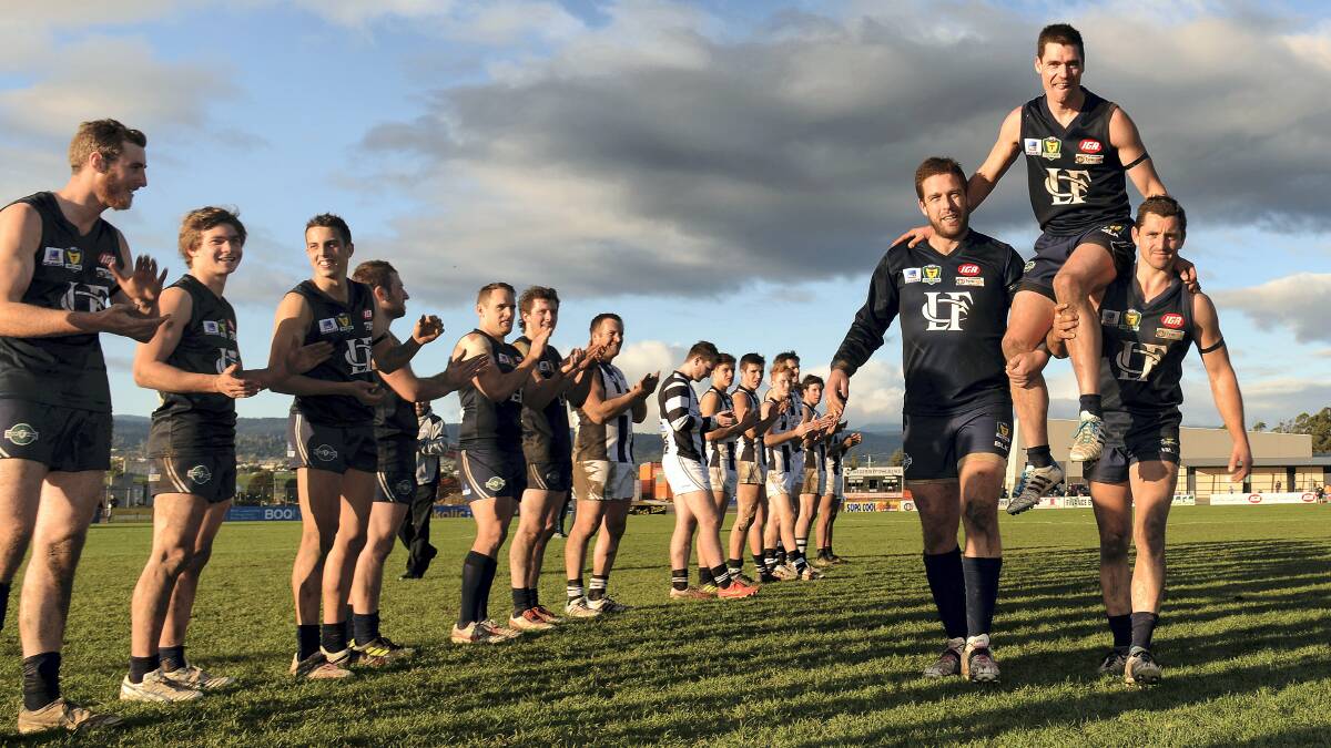 Launceston and Devonport players form a guard of honour as teammates Brennan Savage and Scott Stephens chair game record-breaker  Beau Green off the ground after his  254th game for the Blues yesterday at Windsor Park. Picture: SCOTT GELSTON