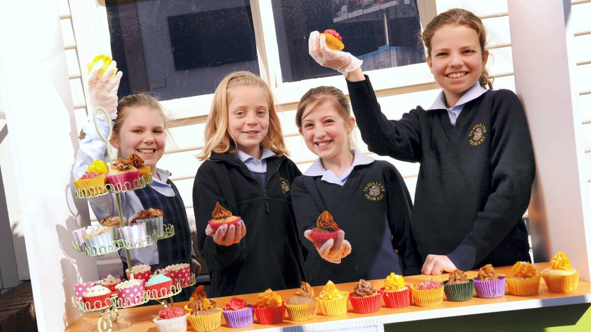 Trevallyn pupils Hannah Sutherland, 9, Emma Elliott, 10, Holli Niland, 10, and Lily Redburn, 10, with some of the 350 cupcakes for the RSPCA Cupcake Day fund-raiser.  Picture: SCOTT GELSTON