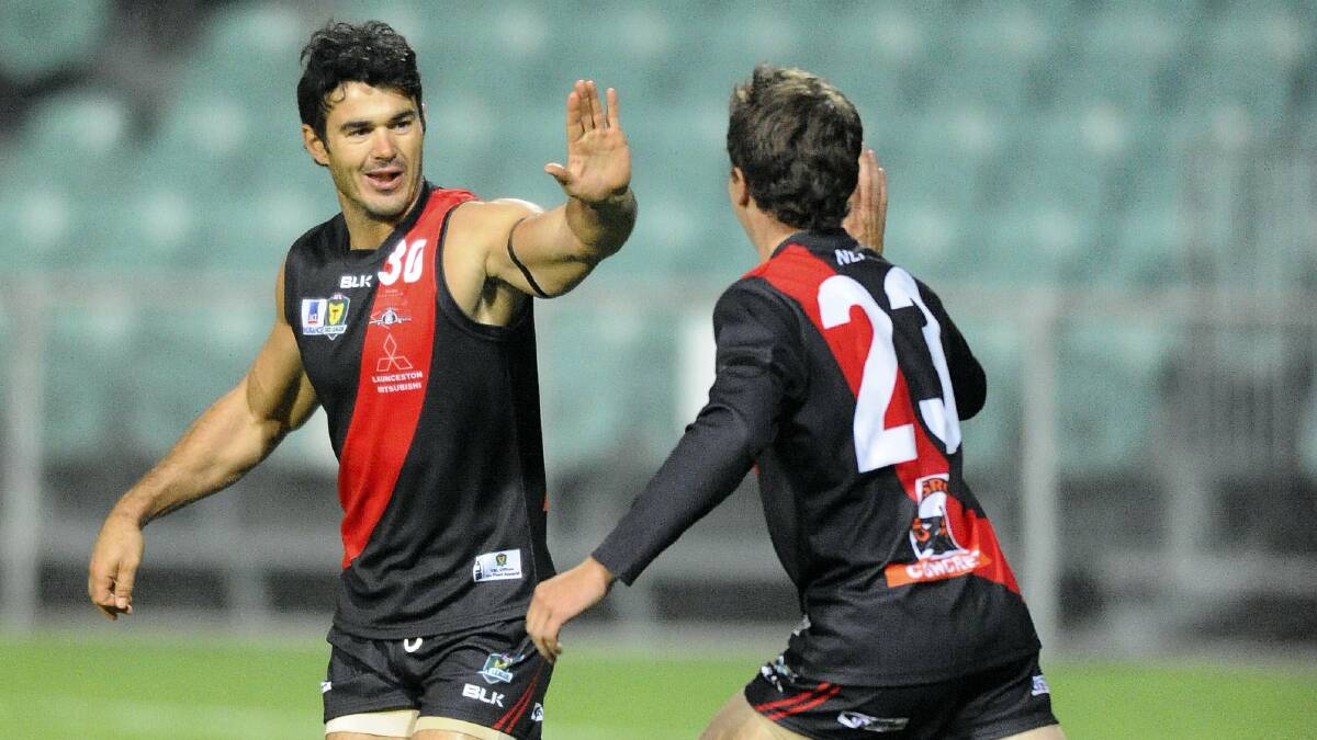 Chris Tarrant high-fives a teammate after one of his goals last night.
